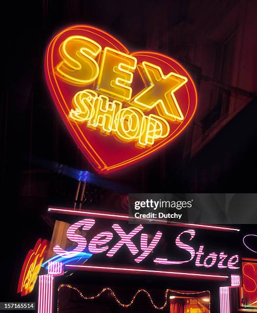 a neon lit sign of a sex shop in pigalle, paris - the place pigalle in paris stock pictures, royalty-free photos & images