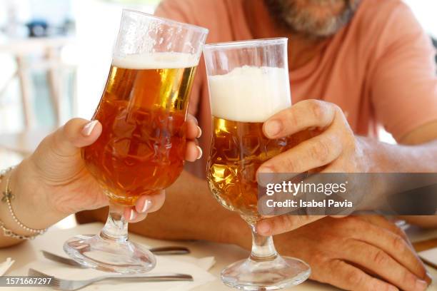 couple toasting with beers - alcohol free stock pictures, royalty-free photos & images