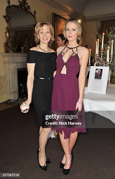 Carrie Cunningham and daughter attends a catwalk show and auction hosted by Browns, Harpers Bazaar and H.E. Alain Giorgio Maria Economides in aid of...