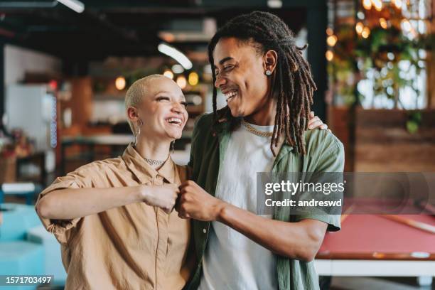 cool work colleagues - fist bump stock pictures, royalty-free photos & images