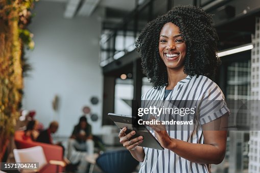 Business woman holding digital tablet smiling Business woman holding digital tablet smiling