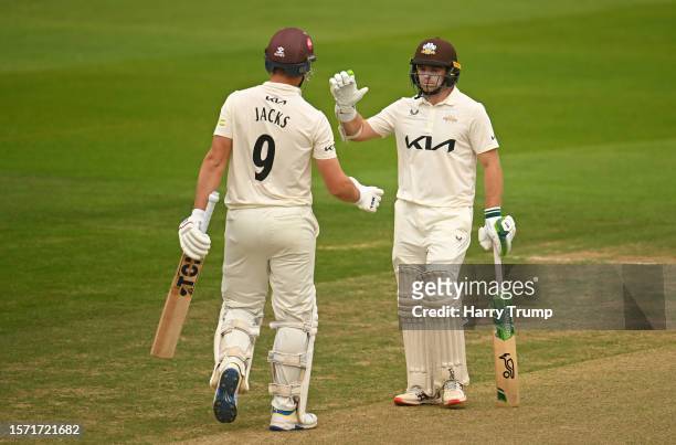 Will Jacks of Surrey celebrates their half century with team mate Tom Latham during Day Two of the LV= Insurance County Championship Division 1 match...