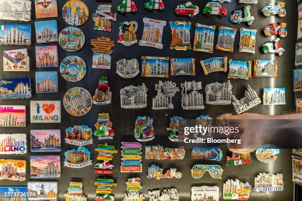 Tourists browse novelty magnets at a souvenir stall in Milan, Italy, on Tuesday, Aug. 1, 2023. Italy's economy unexpectedly contracted in the second...