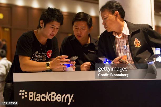 Representative for Research In Motion Ltd. Demonstrates using the BlackBerry 10 smartphone prototype to attendees at the BlackBerry Jam Asia...