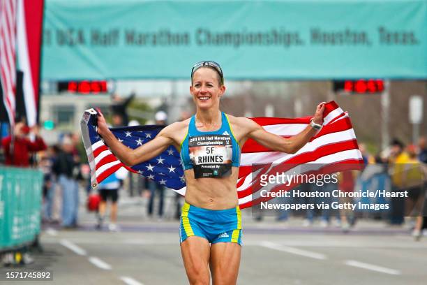 Jen Rhines carries an American Flag after winning the Women's 2011 USA Half Marathon National Championships Saturday, Jan. 29 in Houston.
