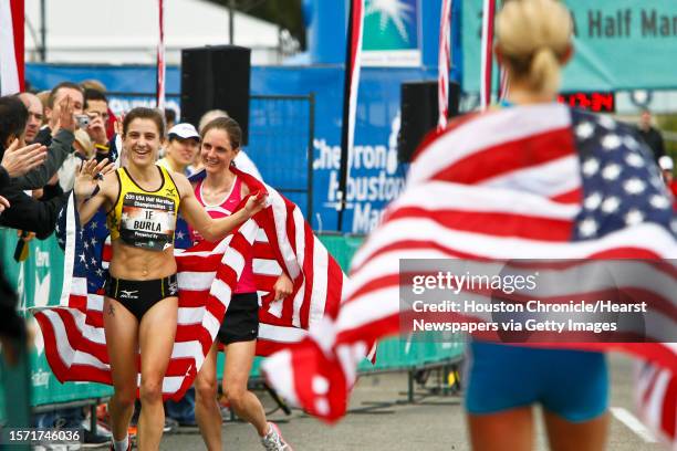 Serena Burla, 2nd place, and Nan Kennard, 3rd place, get congratulated by fans as Jen Rhines, 1st place, looks on during the Women's 2011 USA Half...