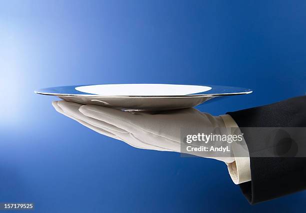 butler serving empty silver tray on blue - gray glove stock pictures, royalty-free photos & images