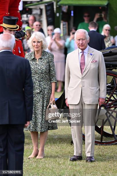 Queen Camilla and King Charles III arrive by carriage for their visit to Sandringham Flower Show at Sandringham House on July 26, 2023 in King's...