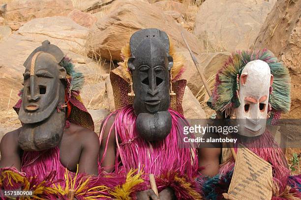 dogon masken dancers: drei der masken - african mask stock-fotos und bilder
