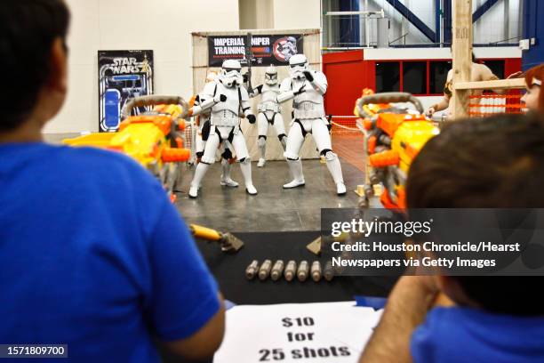 Rohan Masharani and his little brother Devin take aim at stormtroopers at the Imperial Sniper Training Academy sponsored by the 501st Legion during...