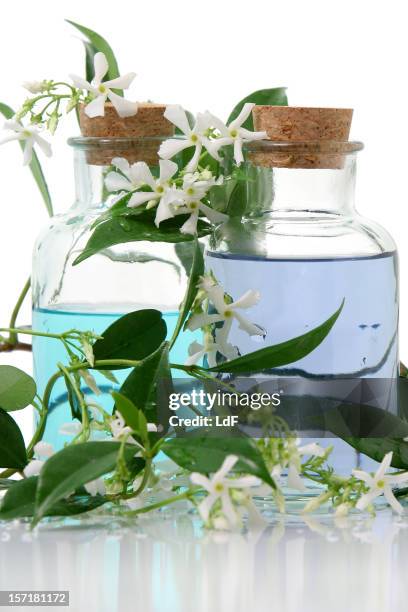aromatherapy products bottles with cork and leaves - jasmine stock pictures, royalty-free photos & images