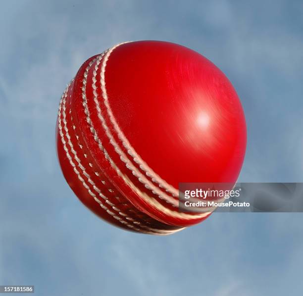 cricket ball spinning against sky - cricket ball stock pictures, royalty-free photos & images