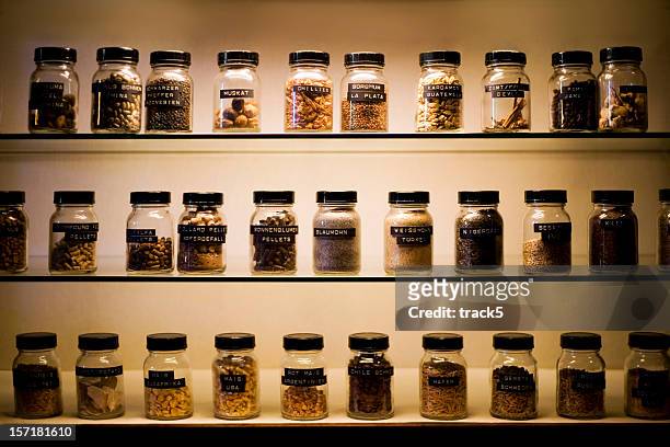 shelves with labeled jars of exotic spices - jars kitchen stock pictures, royalty-free photos & images