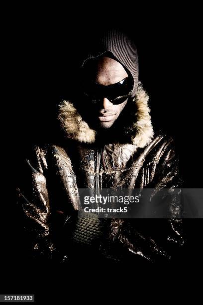 ominous fashion portrait of a dramatically lit black male model - rapper stock pictures, royalty-free photos & images