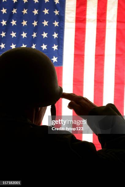 wwii soldier salutes usa flag wearing field dress uniform. america. - military salute stock pictures, royalty-free photos & images