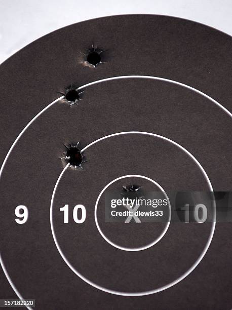bullseye - bullet holes stock-fotos und bilder