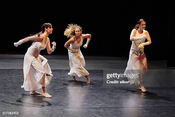 group of contemporary dancers performing on stage. - ballet performance stock pictures, royalty-free photos & images
