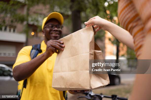 here's your delivery! - take away food courier stock pictures, royalty-free photos & images