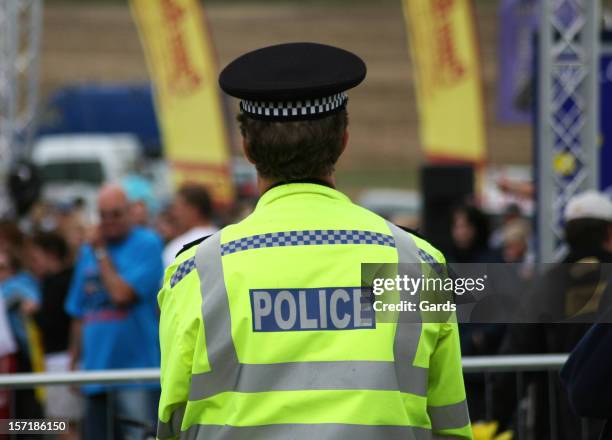 british police man backwards to the camera - police camera stockfoto's en -beelden