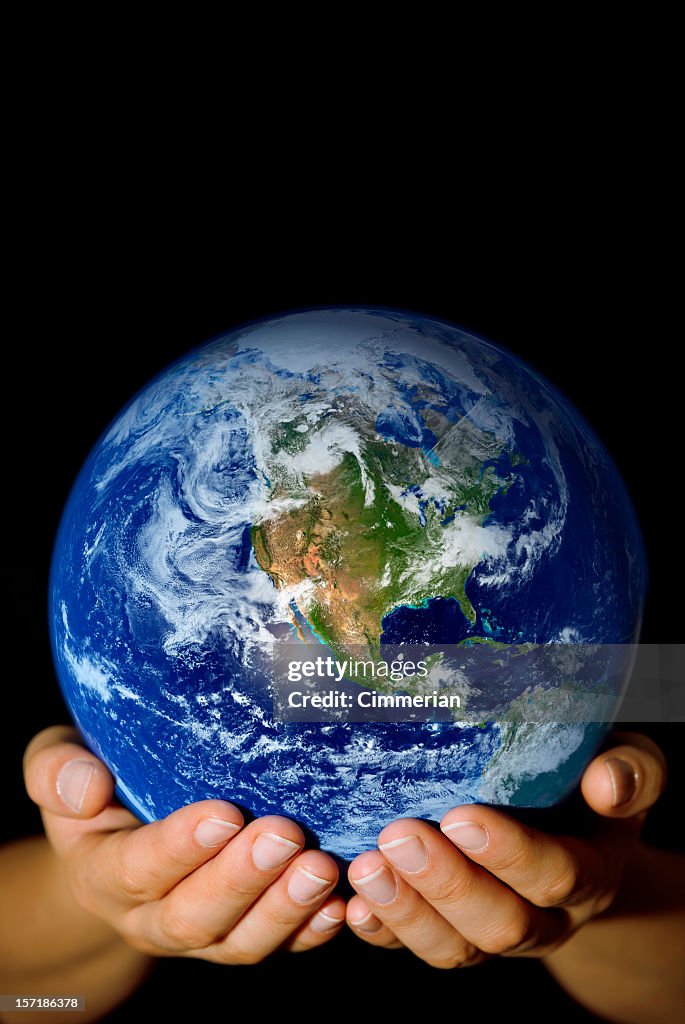Pair of hands holding the Earth with North America visible