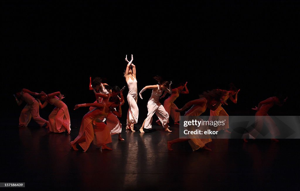 Group of contemporary dancers performing on stage