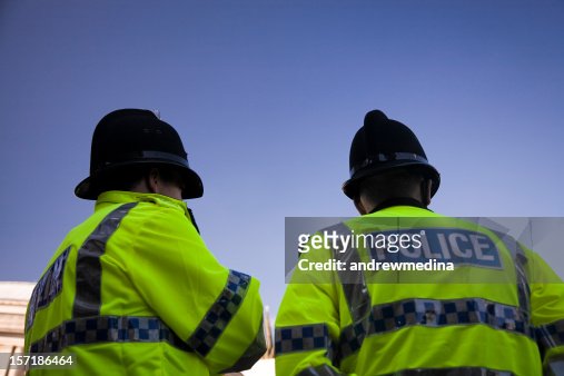 Two British Policemen wearing Traditional Helmets-Click below for more.