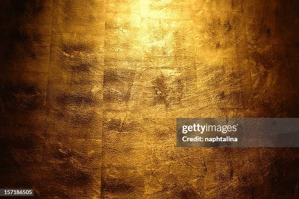 light shining above a golden wall - gold plated texture stock pictures, royalty-free photos & images