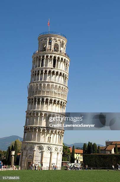 leaning tower of pisa with a flag on top - pisa tower stock pictures, royalty-free photos & images