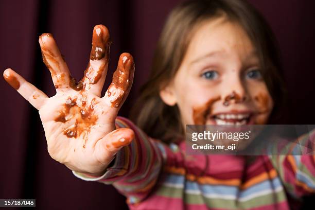 young girl covered in chocolate. - kleverig stockfoto's en -beelden