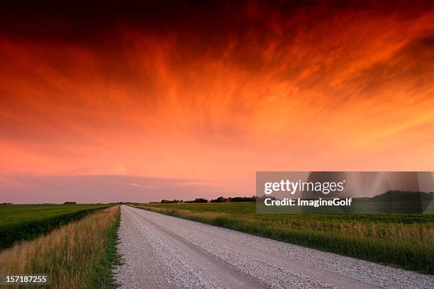 grava road en la región central de estados unidos con un espectacular puesta de sol - manitoba highway fotografías e imágenes de stock