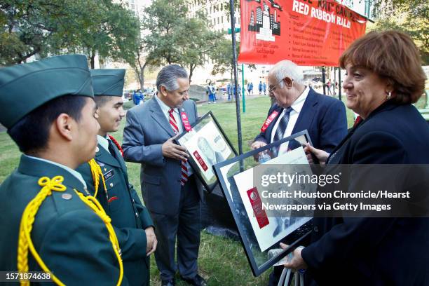 Mary Zapata and her husband Amador , parents of slain immigration agent Jaime Zapata, look at a drawing of their son made by Michael Mendoza and Raul...