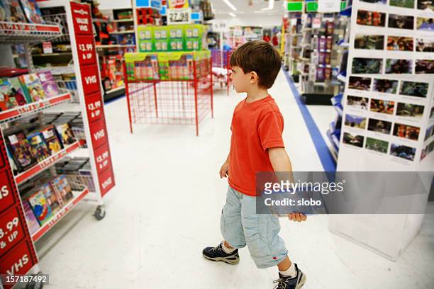 little shopper in toy store - toy store stock pictures, royalty-free photos & images