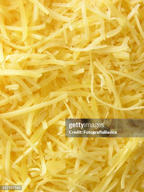 grated cheese background - emmental cheese stock pictures, royalty-free photos & images