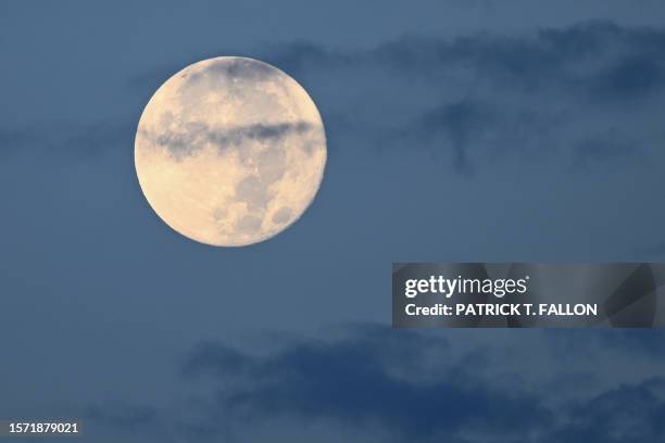 The Sturgeon super moon sets in Las Vegas, Nevada on August 2, 2023.