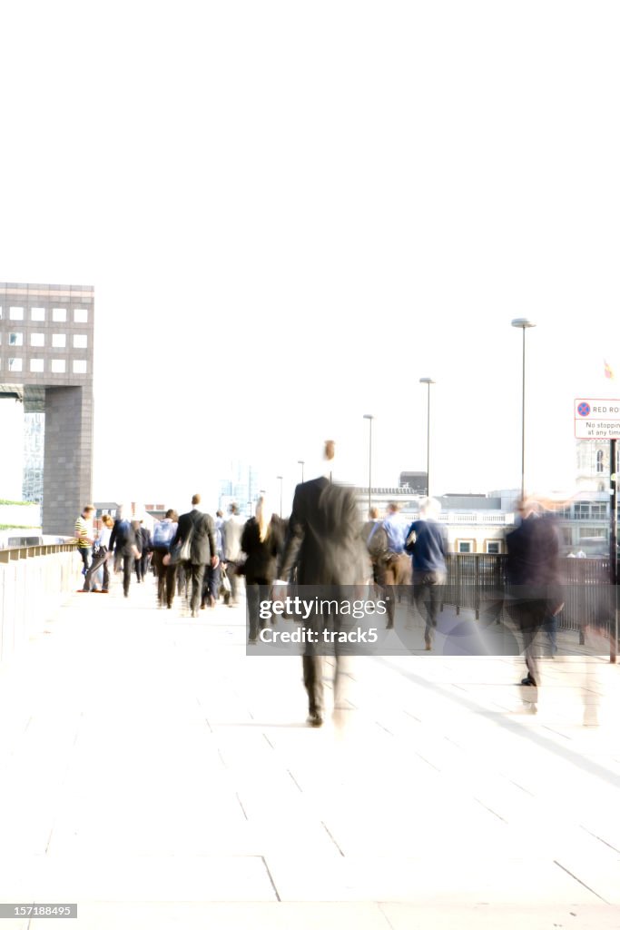 Abstract, blurred City workers rushing across London Bridge