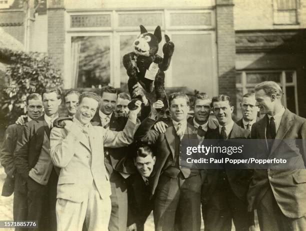 Bolton Wanderers players pose for a photo with a good luck mascot outside their hotel in Harrow before the Wembley FA Cup final appearance against...