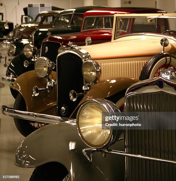 a showroom with a collection of vintage cars - car show stock pictures, royalty-free photos & images