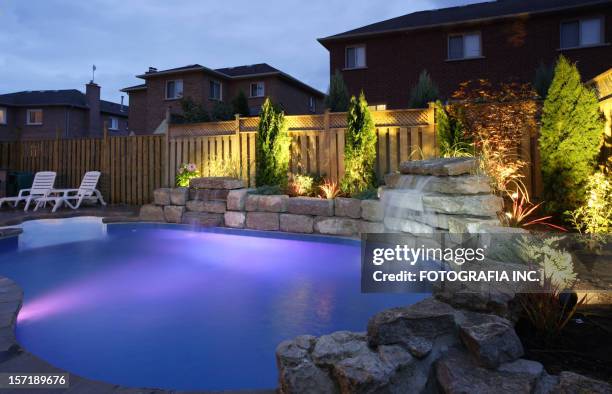 backyard pool at night - swimming pool night stock pictures, royalty-free photos & images