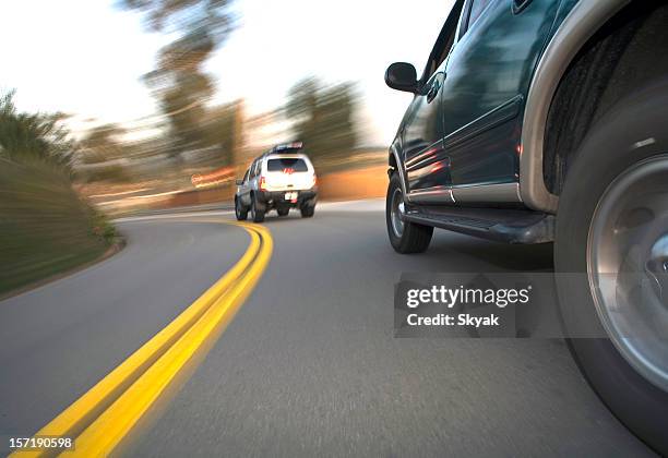 suv side shot in corner 2 - pursued stock pictures, royalty-free photos & images
