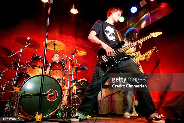 rock band in action - performance group stock pictures, royalty-free photos & images