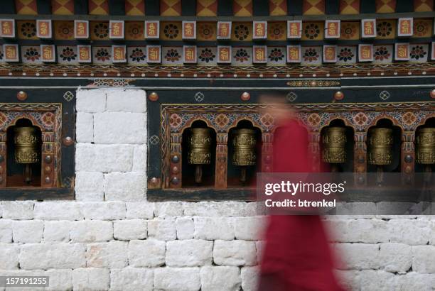 prayer wheels with monk - bhutan stock pictures, royalty-free photos & images