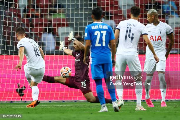 Giovani Lo Celso of Tottenham Hotspur scores his team's fourth goal against Zharfan Rohaizad of the Lion City Sailors during the second half of the...