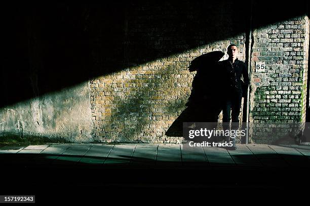 high contrast, full length portrait of a confident urban character - black man high 5 stockfoto's en -beelden