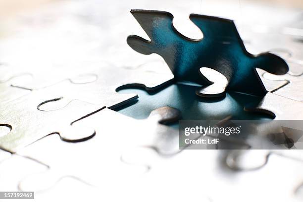 jigsaw piece backlit - togetherness stock pictures, royalty-free photos & images