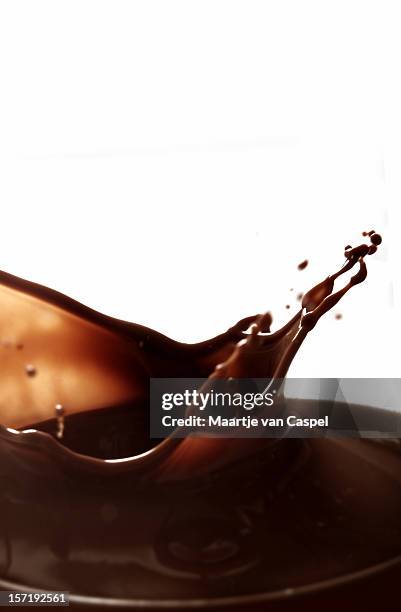 image of something splashing in chocolate - chocolate shake stock pictures, royalty-free photos & images