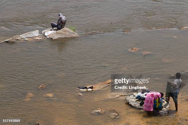 african way of washing - laundry africa stock pictures, royalty-free photos & images