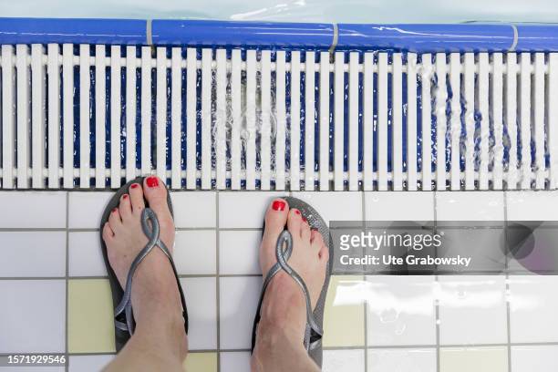 In this photo illustration feet in a public swim hall on August 02, 2023 in Bornheim, Germany.