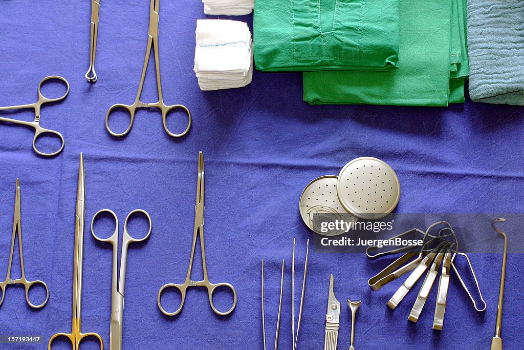 Surgical instruments arrayed on a purple cloth background
