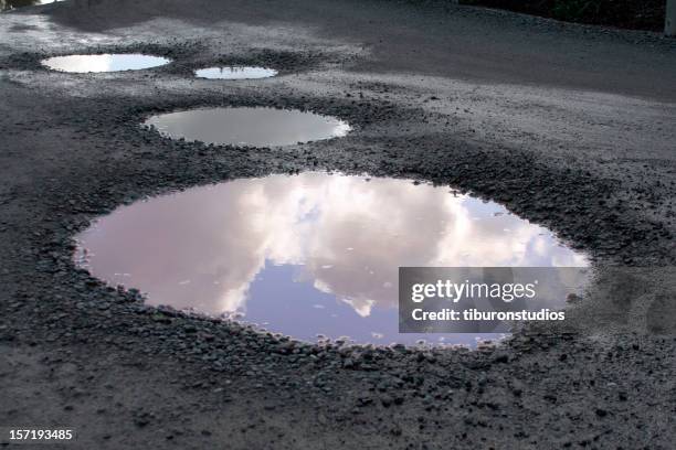 blauer himmel, die sich nach dem regen - puddles stock-fotos und bilder