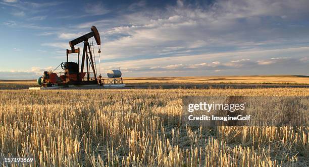 prairie pumpjack in alberta oil industry - alberta canada stock pictures, royalty-free photos & images